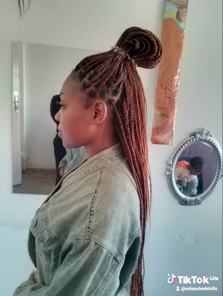 Auburn braids styled with soft curls