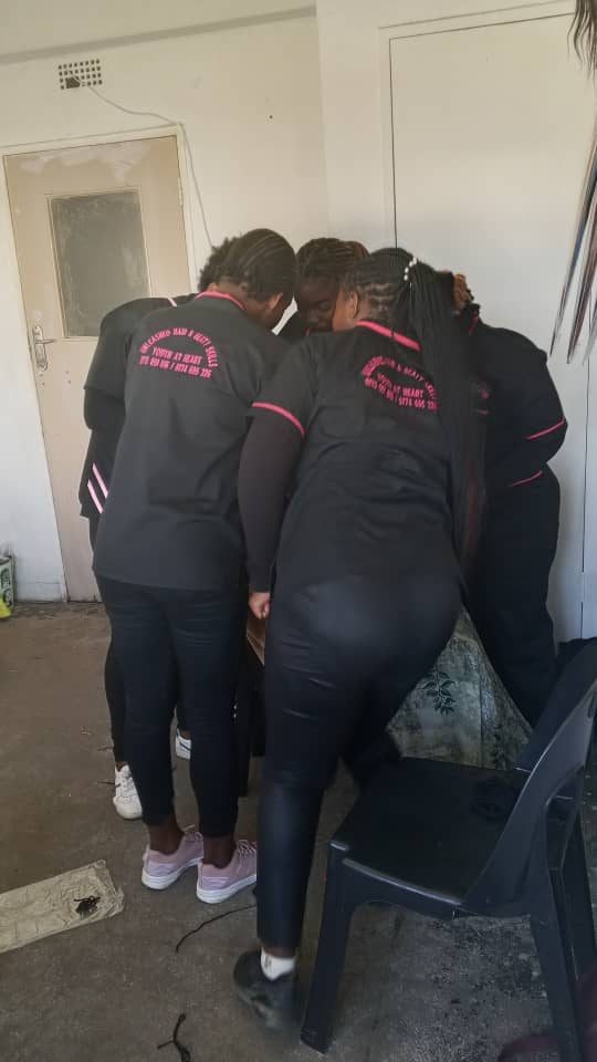 Trainees in branded Unleashed Hair & Beauty Skills uniforms