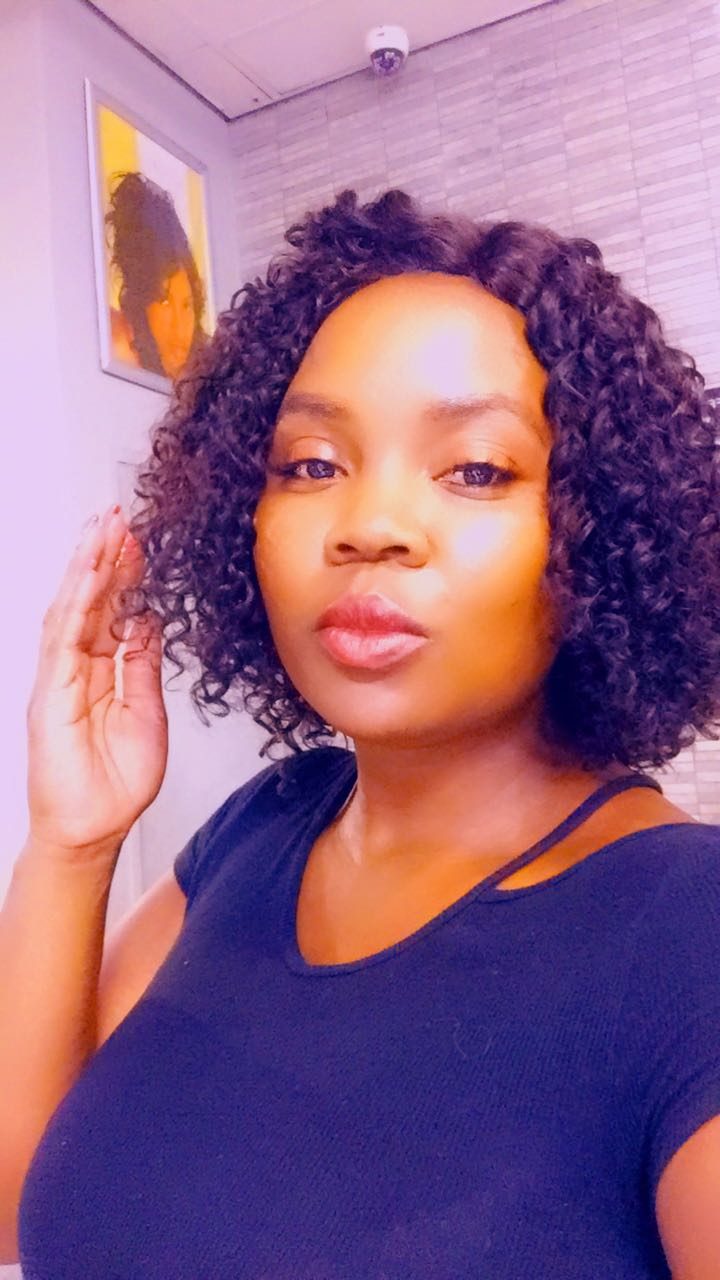Client wearing a curly bob wig