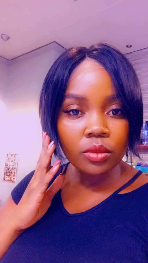 Client wearing a sleek straight bob wig