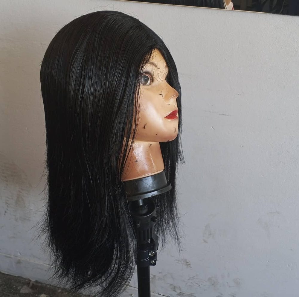 Long straight wig unit prepared on a mannequin