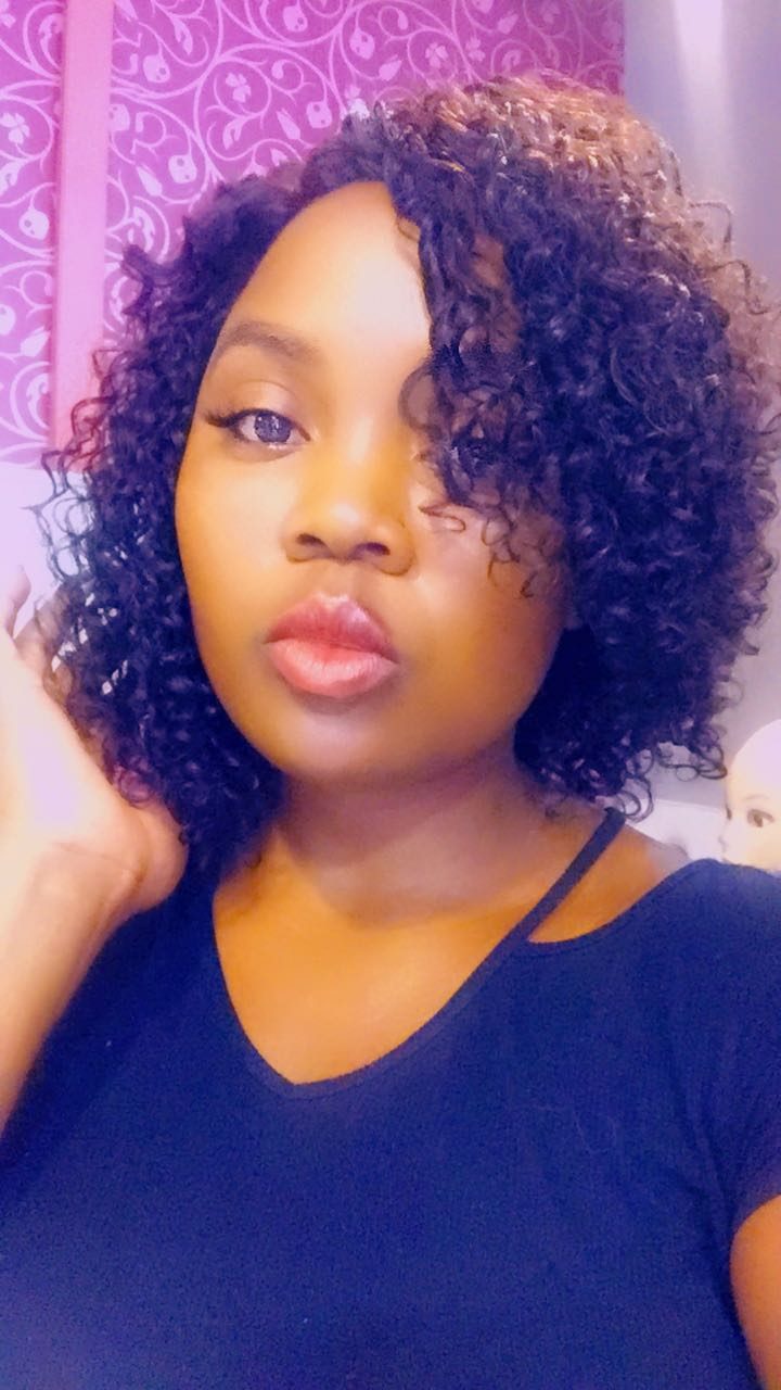 Client wearing a dark curly bob wig