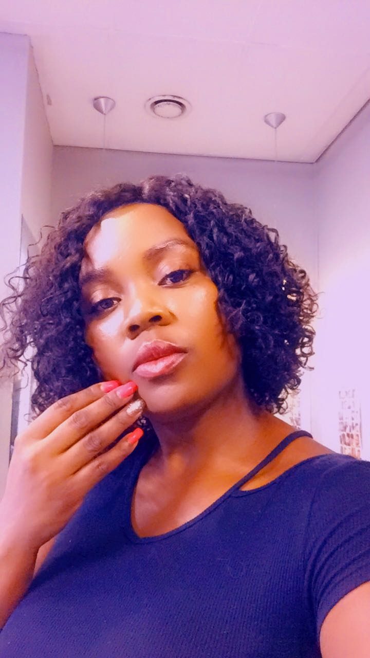 Client wearing a curly bob wig